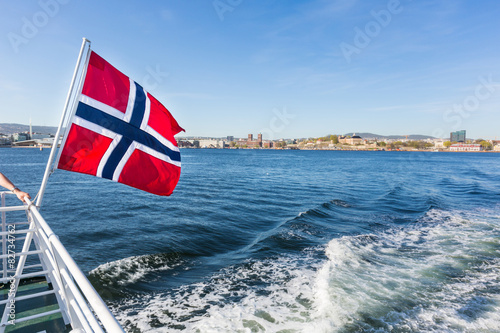 Photography Norwegian flag waving on poop of a boat in Oslo
