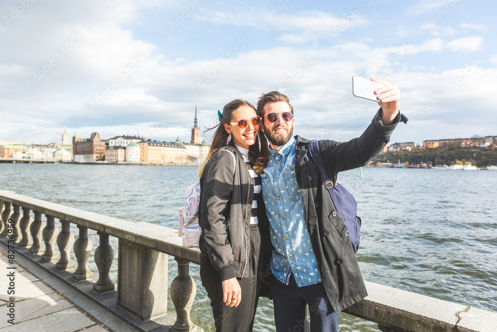 Young hipster couple taking a selfie in Stockholm