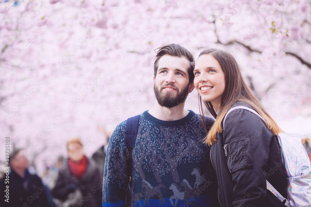 Hipster couple portrait in Stockholm with cherry blossoms