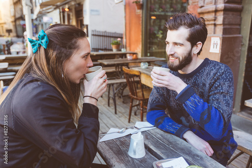 Photography Hipster couple drinking coffee in Stockholm old town.