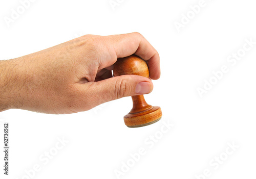 Hand stamping with an old and vintage wooden stamper isolated on