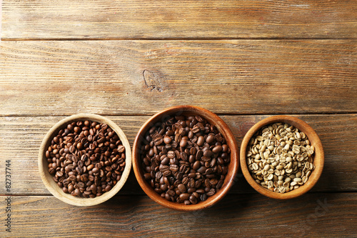 Coffee beans on wooden table, top view