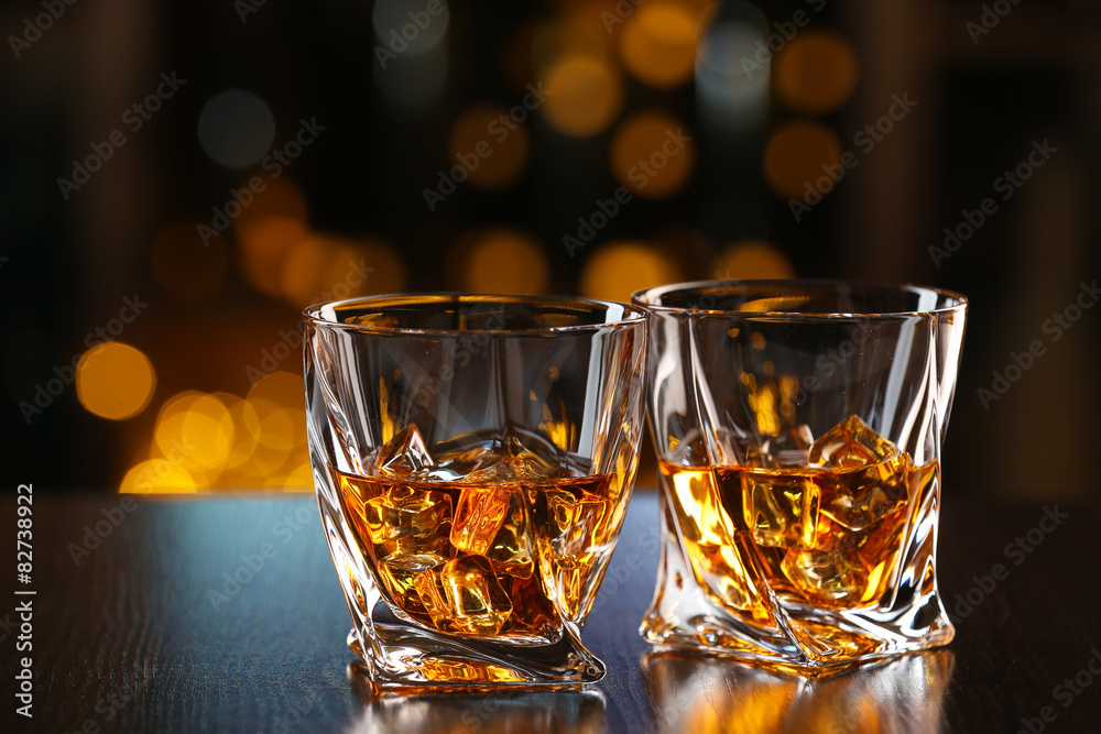 Glasses of whiskey on bar background Glasses of whiskey on bar background