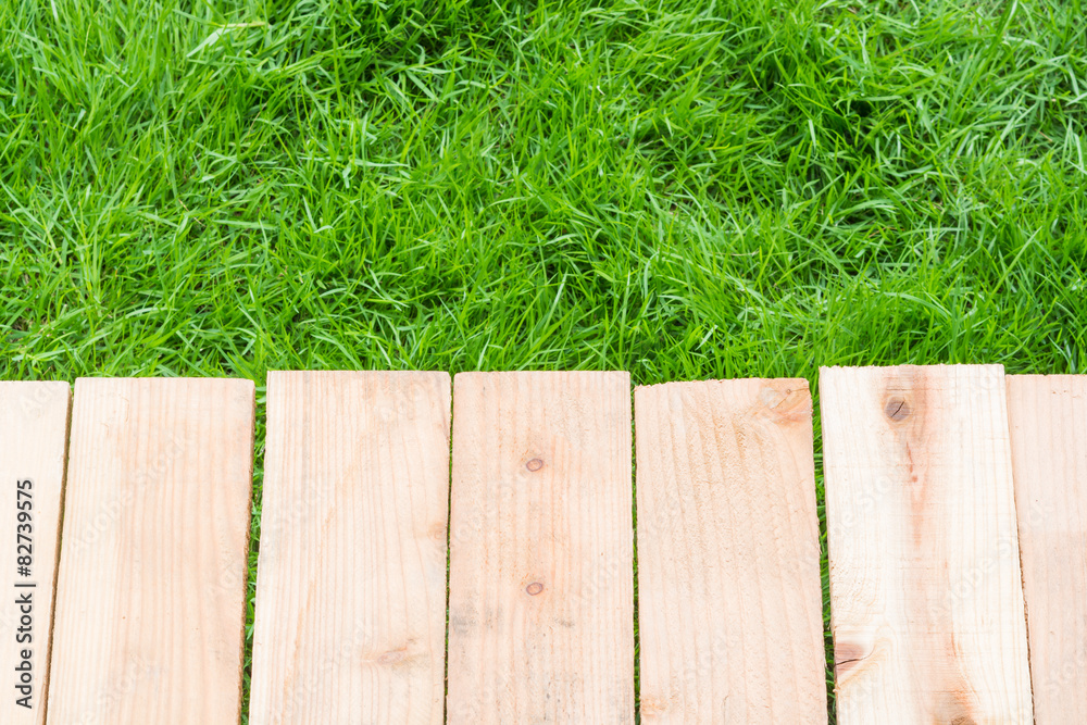 Fototapeta premium Wood on grass background