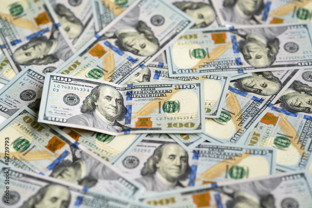 hundred dollar bill on pile of money hundred dollar bill on pile of money
