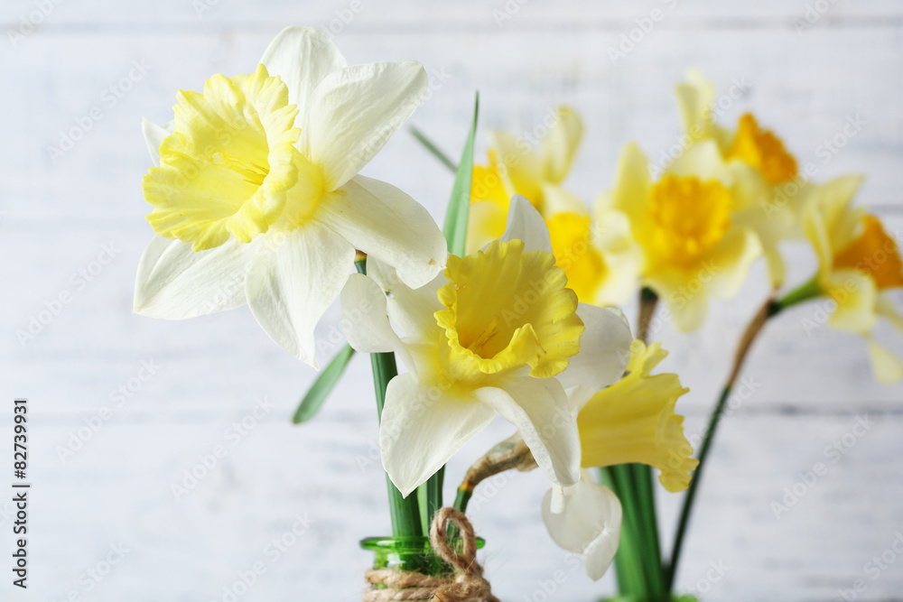 Fresh narcissus flowers on wooden background