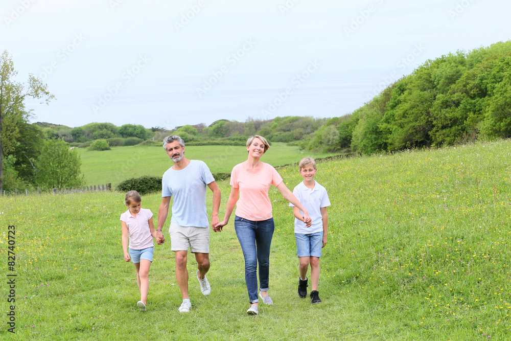 Family walking on country trail during vacation time Family walking on country trail during vacation time