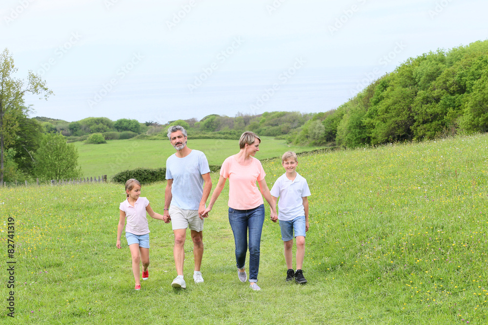 Family walking on country trail during vacation time Family walking on country trail during vacation time