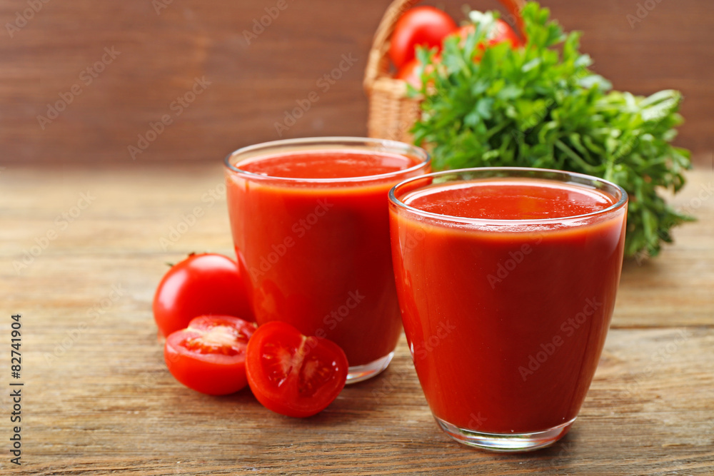 Glasses of fresh tomato juice on wooden background Glasses of fresh tomato juice on wooden background