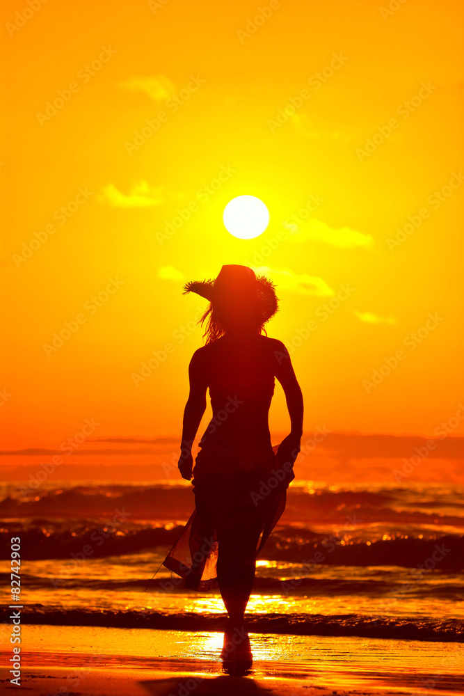 young woman on the beach in summer sunset