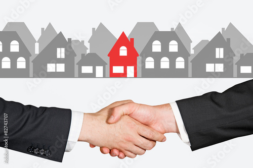 People shaking hands in a real estate transaction