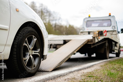 Loading broken car on a tow truck on a roadside © Nejron Photo
