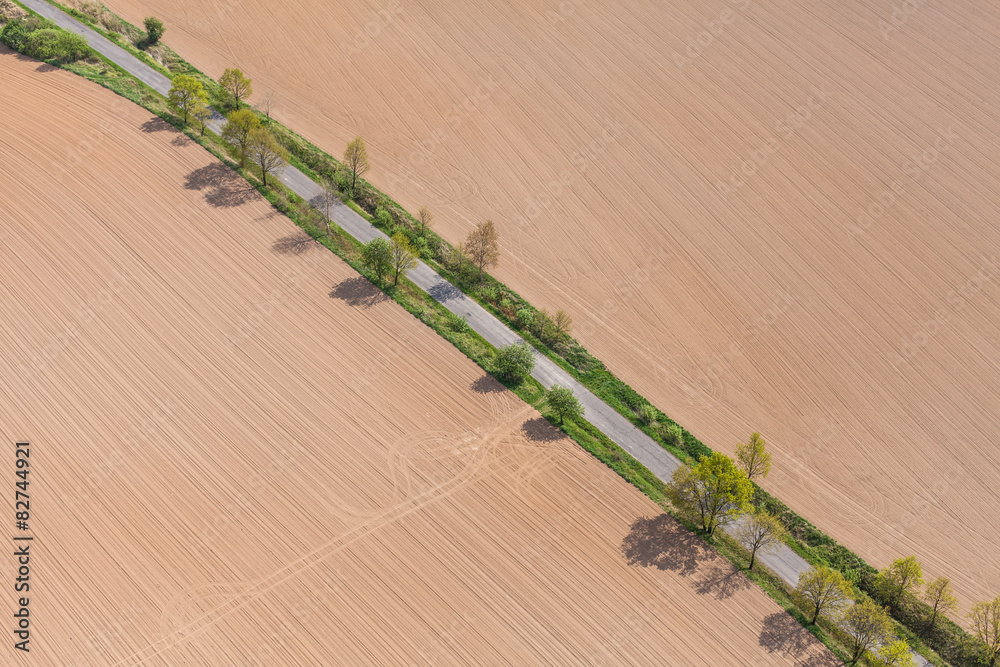Naklejka premium aerial view of village road and harvest fields