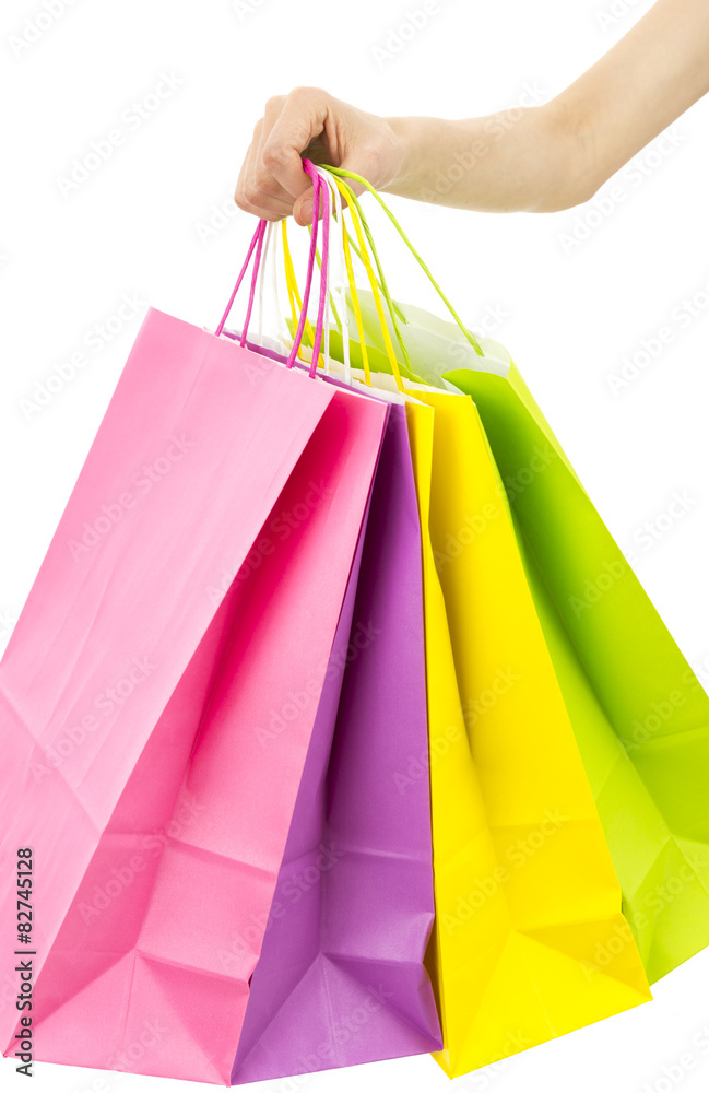 Hand holding colorful paper shopping bags