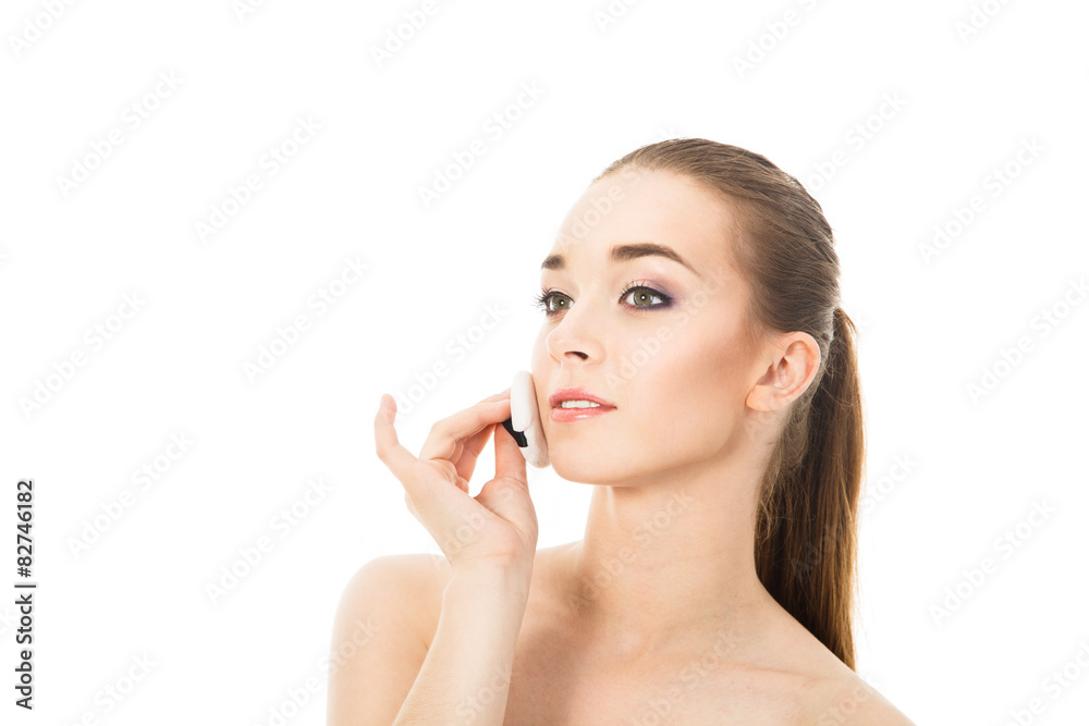 beautiful woman applying powder
