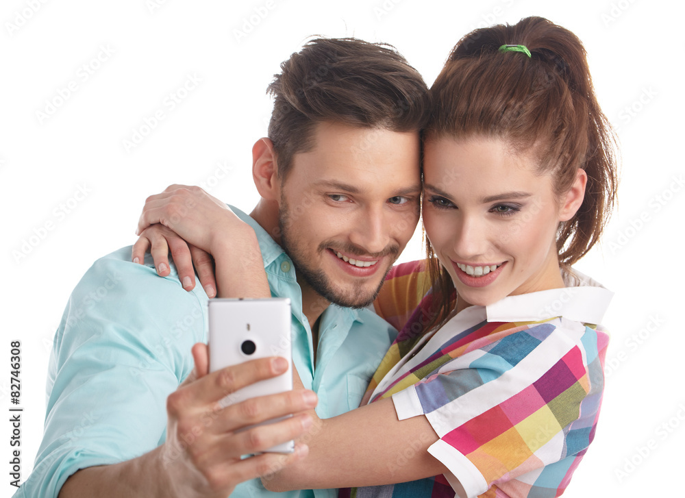 Happy hipster couple taking a selfie on white background Happy hipster couple taking a selfie on white background
