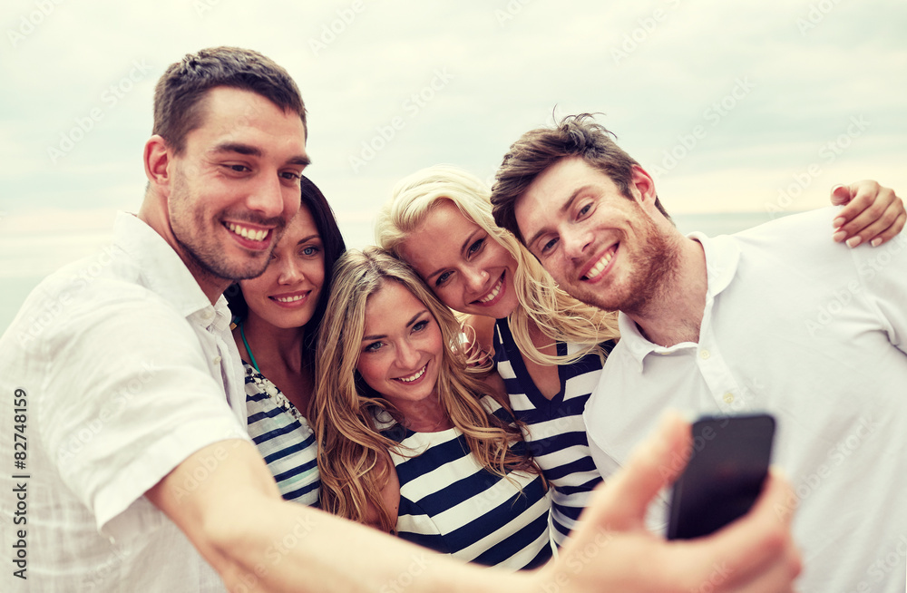happy friends on beach and taking selfie happy friends on beach and taking selfie
