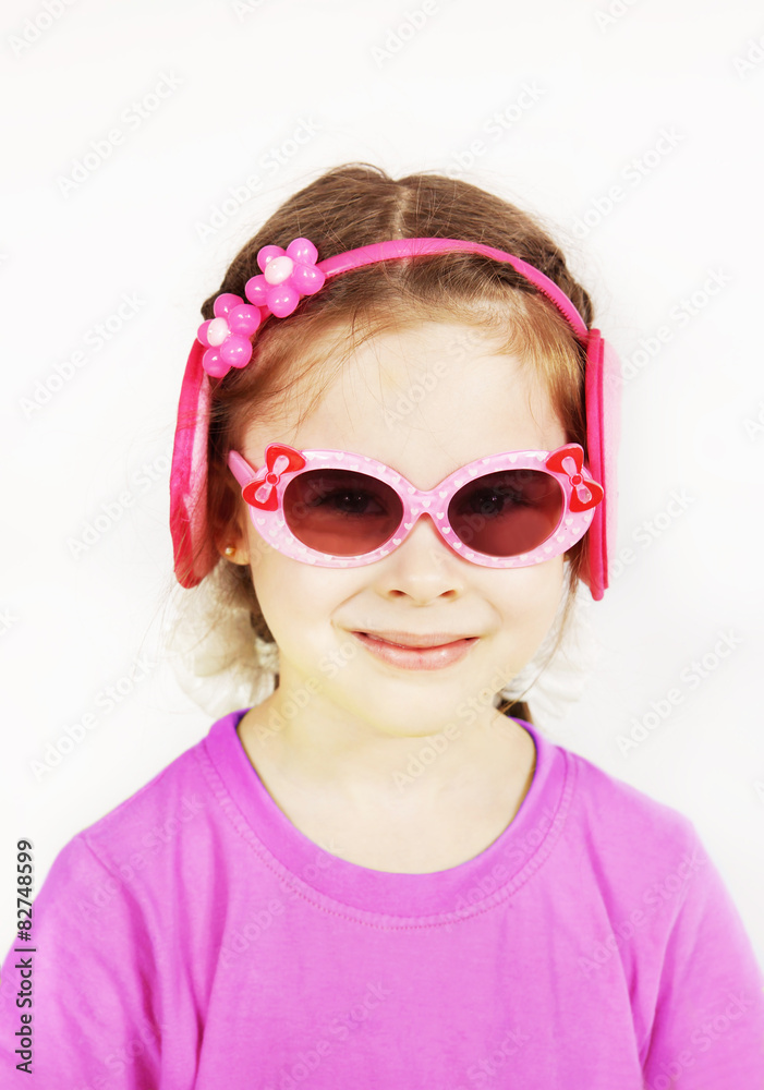 Smiling little cute girl wearing pink sunglasses