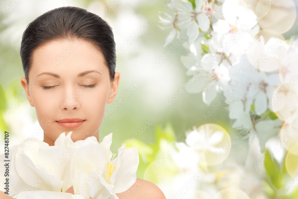 beautiful woman smelling flowers with closed eyes beautiful woman smelling flowers with closed eyes