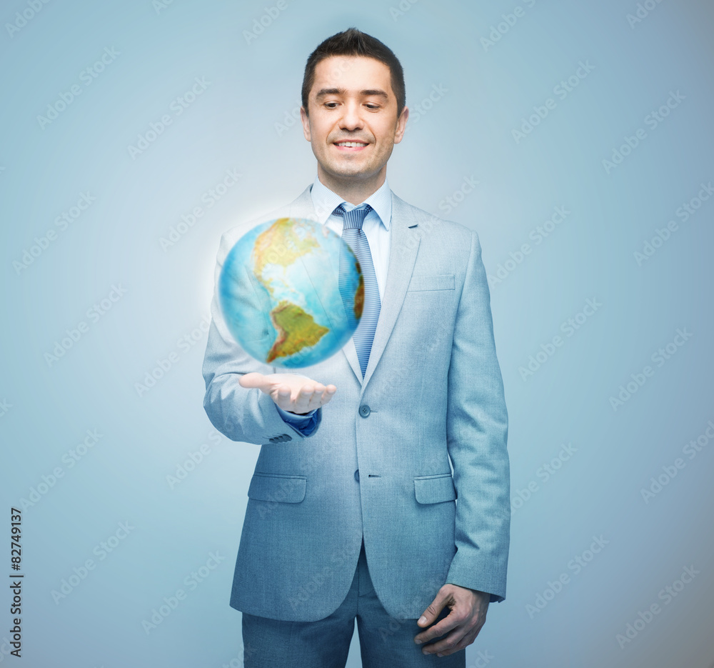happy businessman in suit showing globe hologram happy businessman in suit showing globe hologram