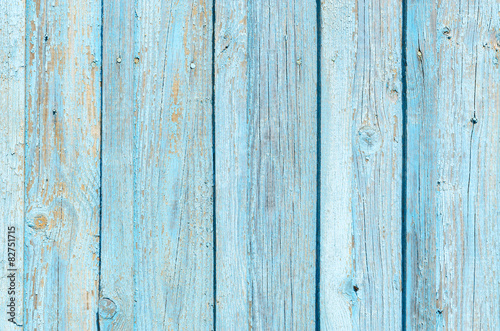 Texture of old wooden fence with cracked blue paint
