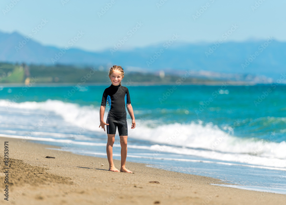 happy little girl in a wetsuit 