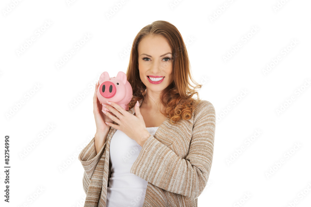 Casual woman holding piggy-bank. Casual woman holding piggy-bank.