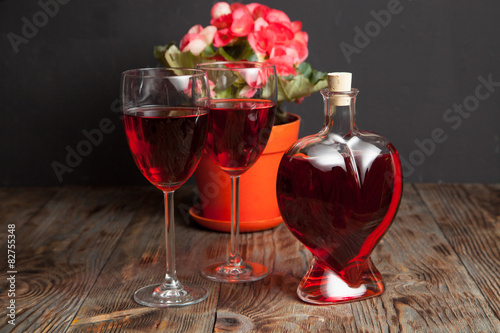 Bottle with red wine and flower