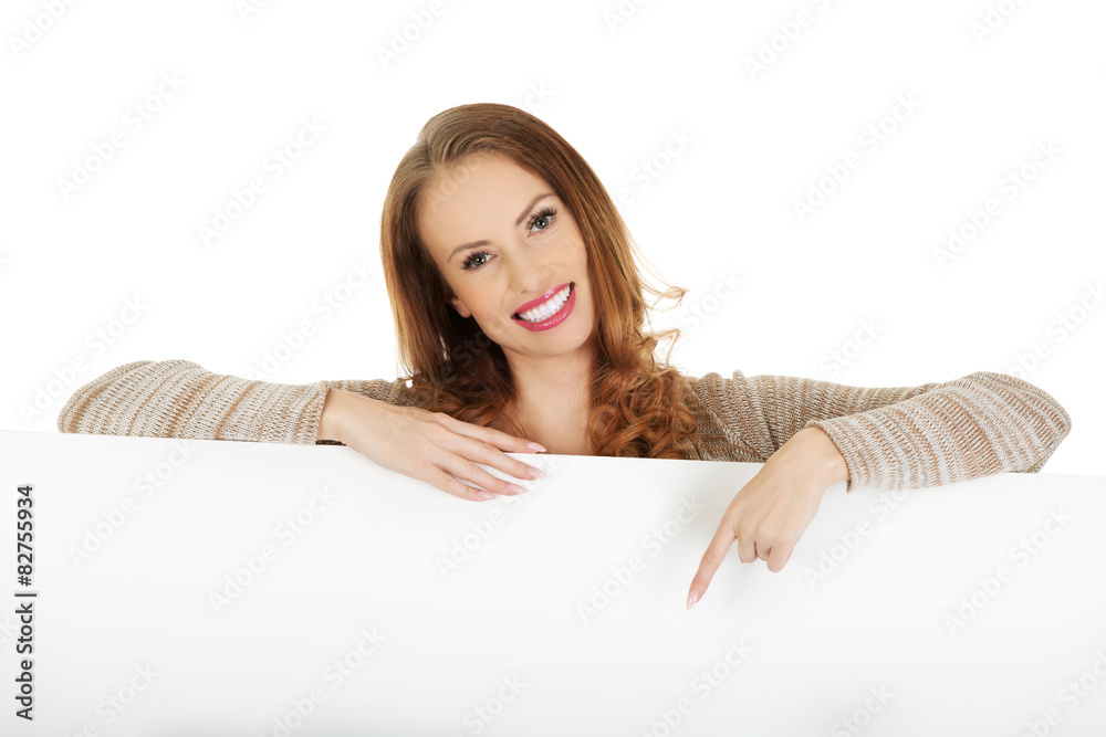 Happy woman pointing on blank board. Happy woman pointing on blank board.
