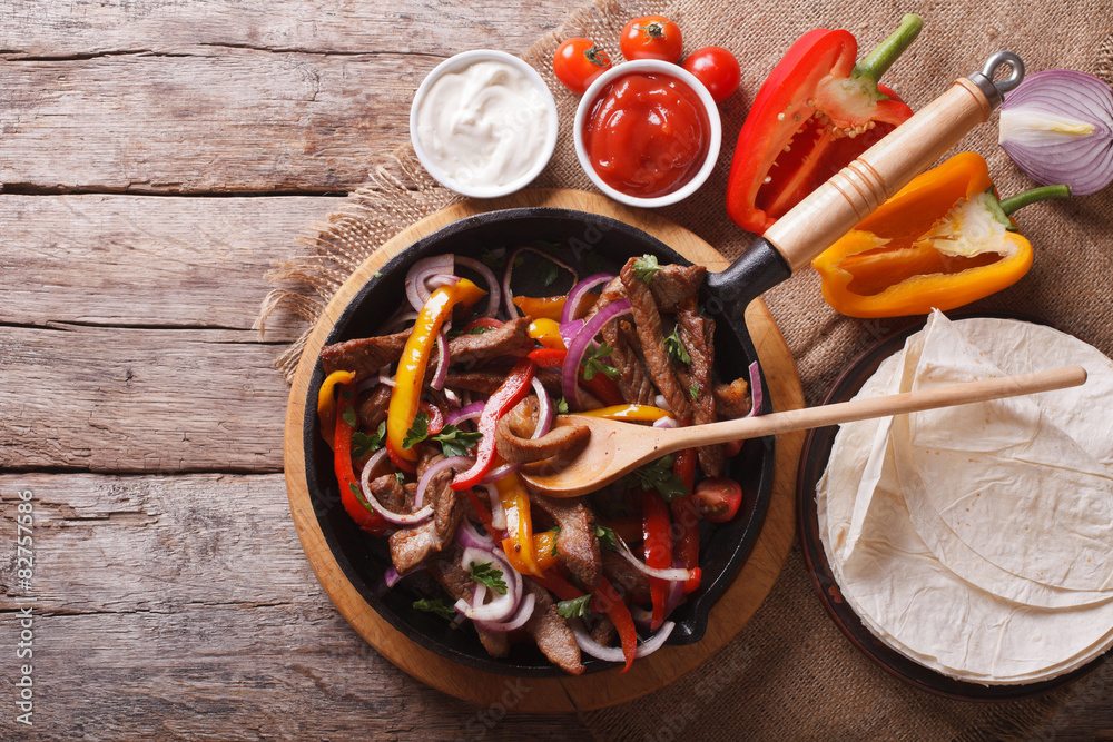 Fototapeta Mexican fajitas on a table. horizontal top view