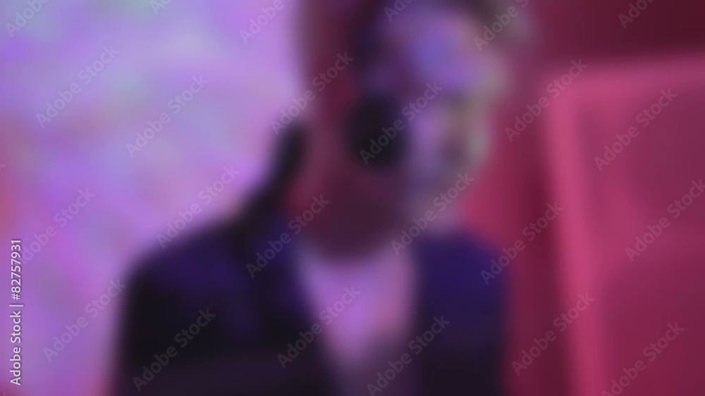 Young man performing DJ set, dancing to music, mixing records