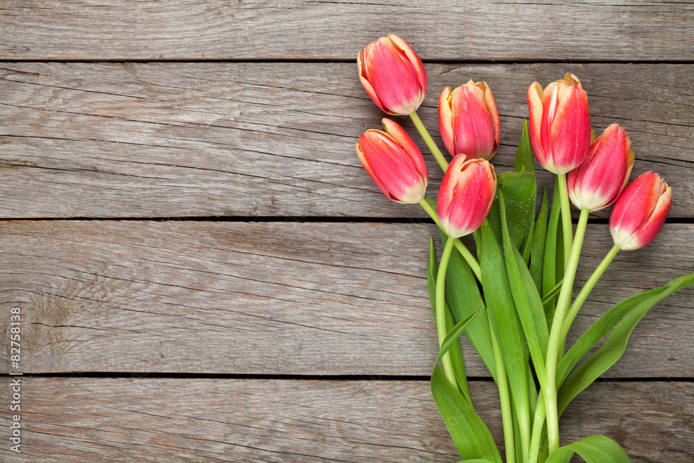 Fototapeta premium Colorful tulips on wooden table