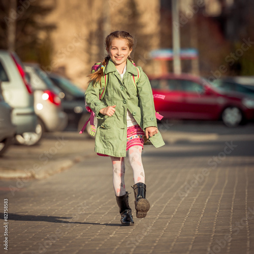 happy little girl running from school