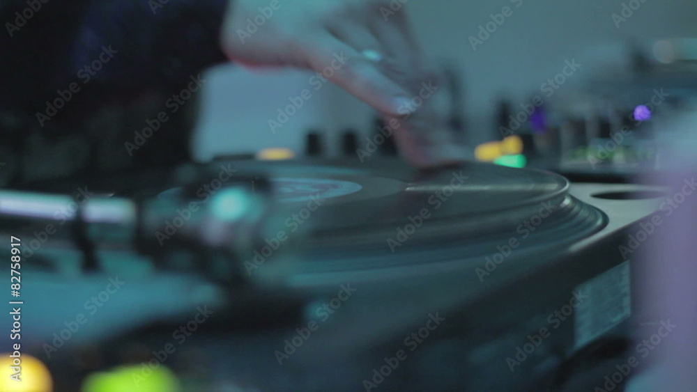 DJ mixing records, playing music, hands scratching vinyl platter DJ mixing records, playing music, hands scratching vinyl platter