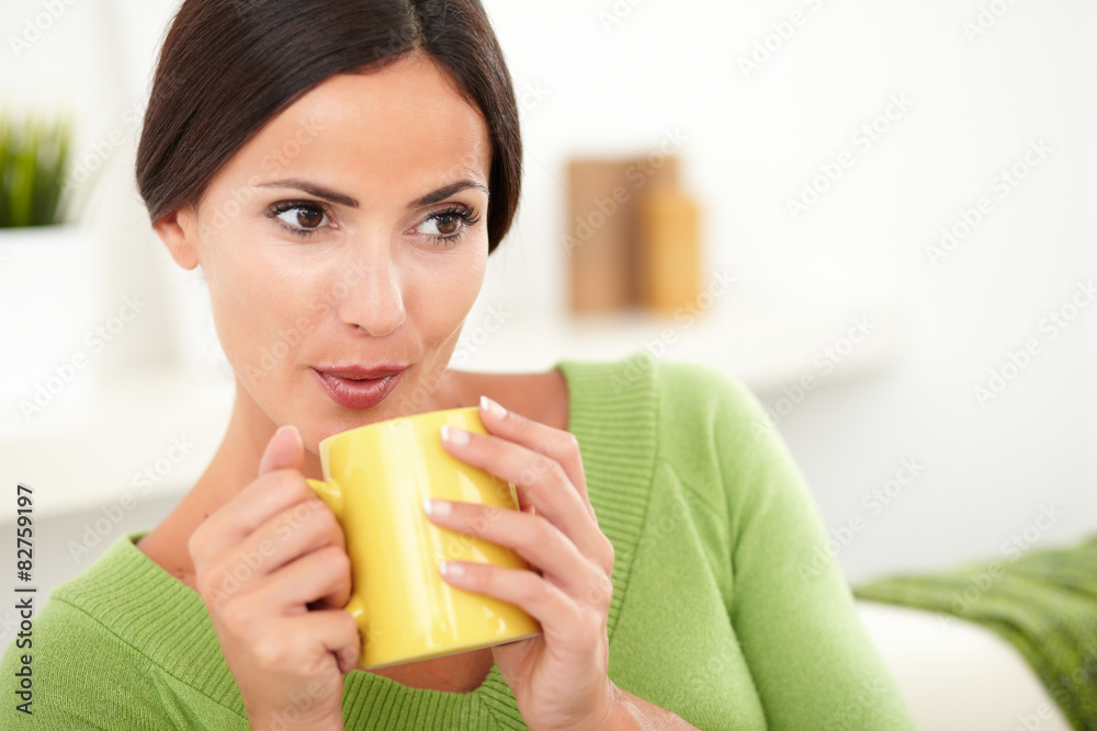 Attractive caucasian woman blowing on hot coffee