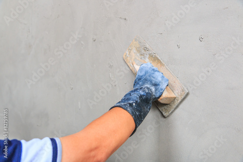 Plasterer concrete at construction site