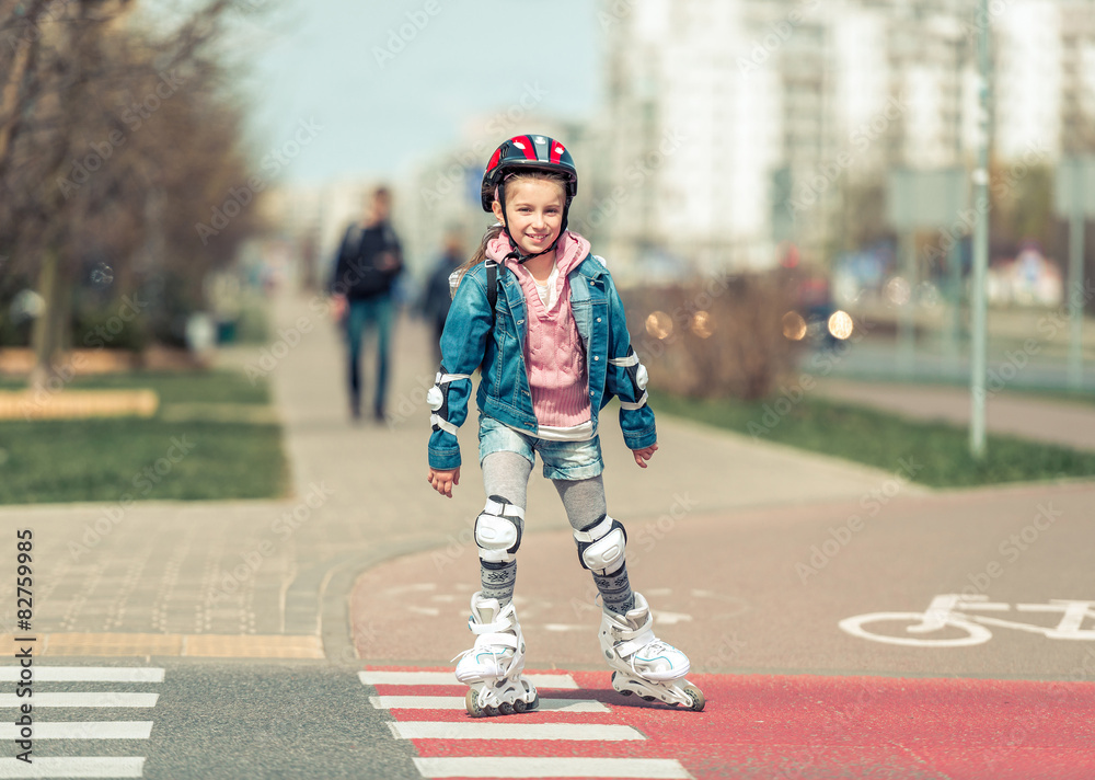 little cute girl riding on roller skates 
