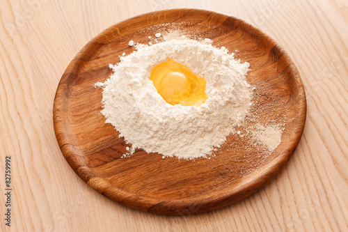 Broken egg on flour