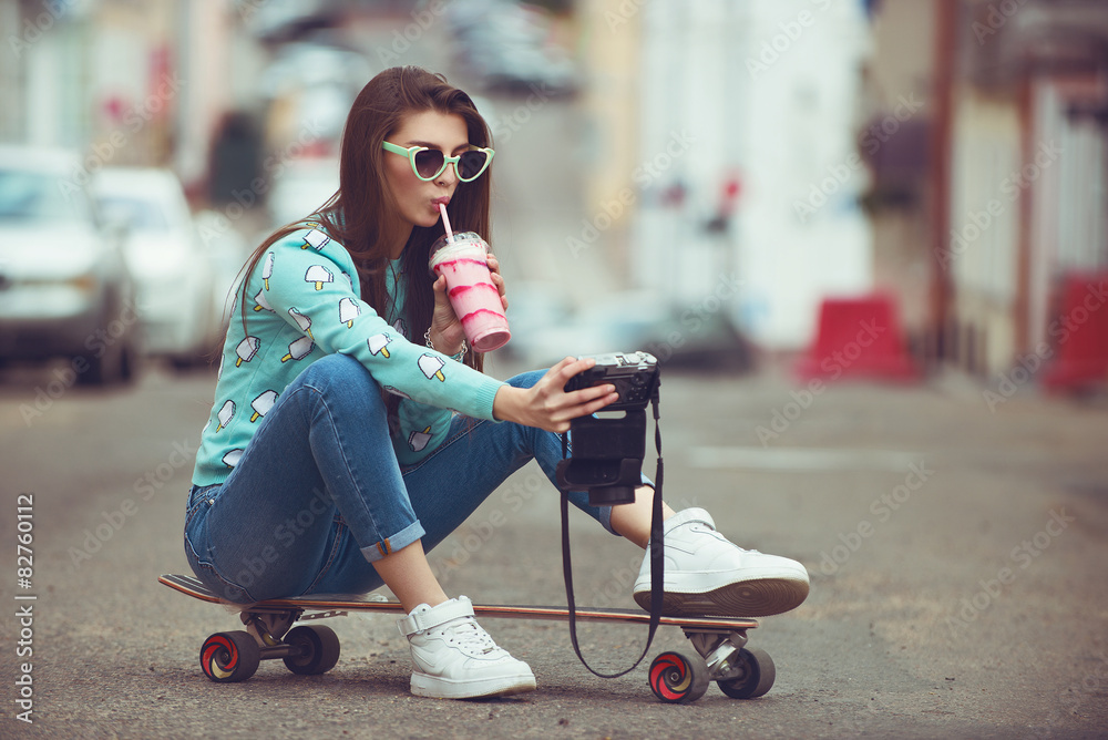 Beautiful young woman posing with a skateboard, fashion - obrazy, fototapety, plakaty 