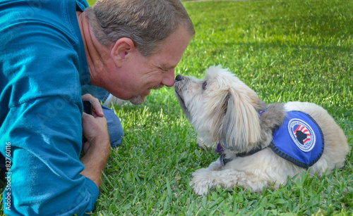 Photography Older man sharing a precious encounter with his service dog