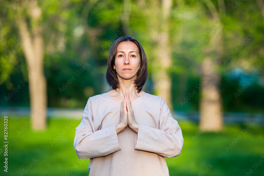 Practicing yoga in the morning, with trees background Practicing yoga in the morning, with trees background