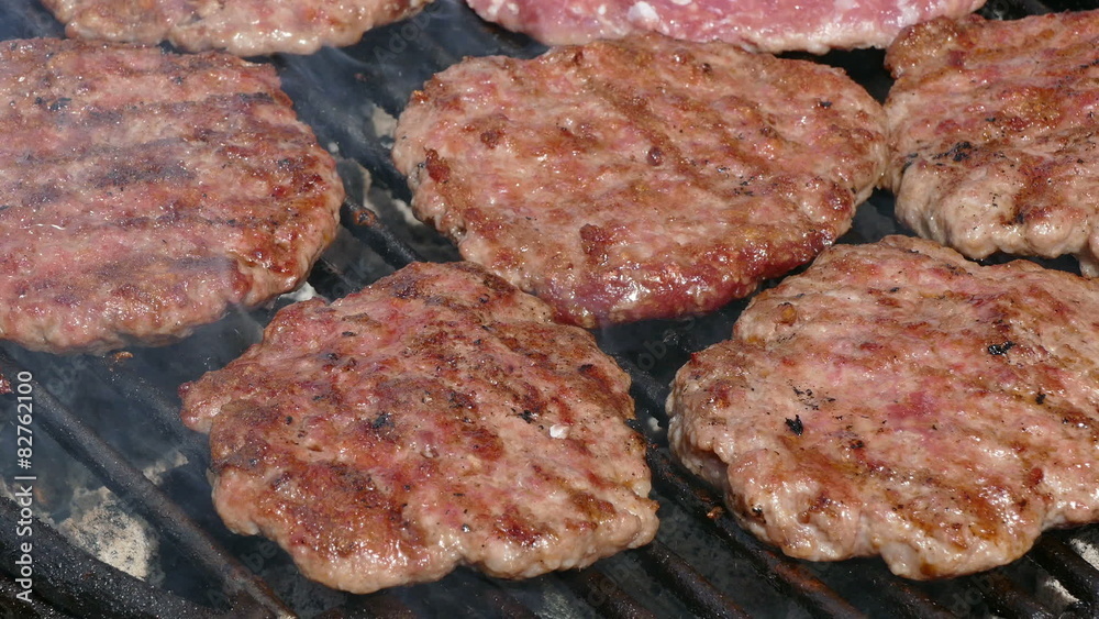 Barbecue, preparing hamburger on classical way cook turning meat Barbecue, preparing hamburger on classical way cook turning meat