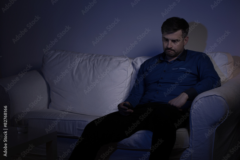 Lonely man spending evening alone Lonely man spending evening alone