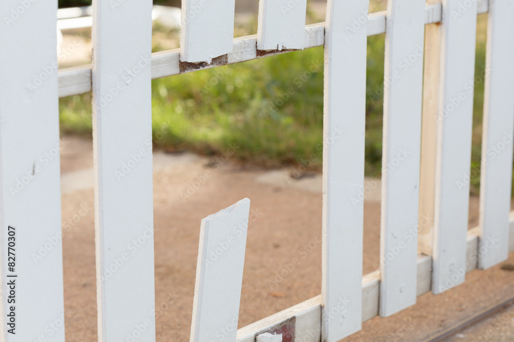 Fototapeta premium white wood fence of broken damaged