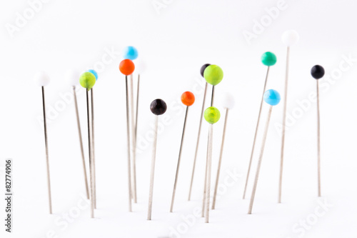 Many sewing push pins isolated on white background