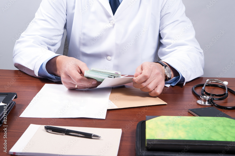 Fototapeta premium A doctor taking a bribe from a patient