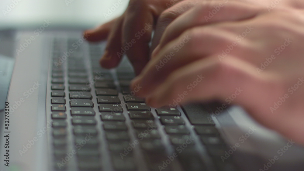Close up of male fingers pressing buttons on laptop keyboard Close up of male fingers pressing buttons on laptop keyboard
