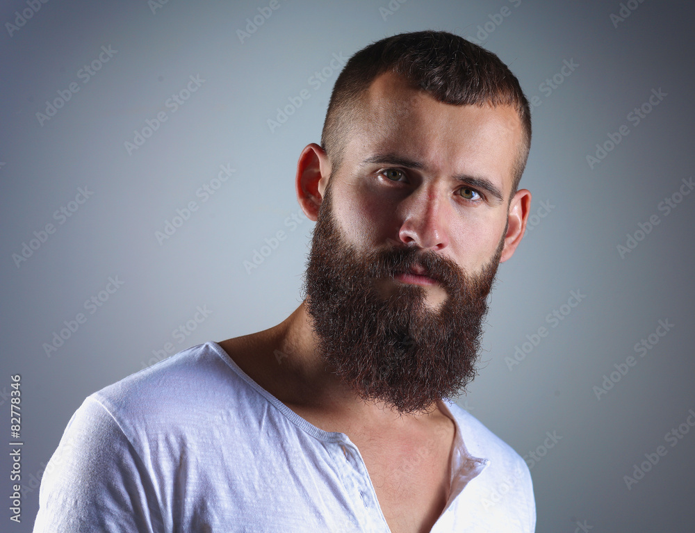 Portrait of handsome bearded man isolated on grey background Portrait of handsome bearded man isolated on grey background