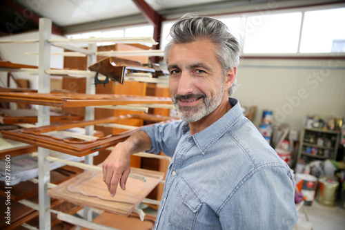 Smiling carpenter standing in workshop