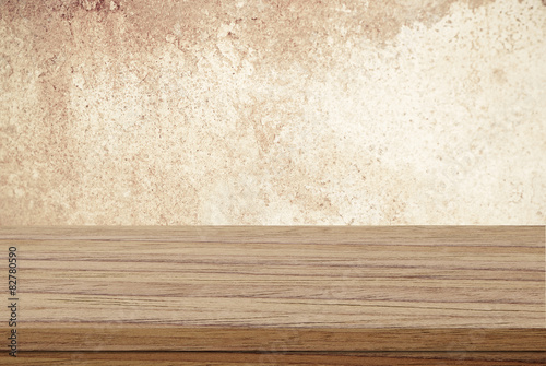 Empty wooden table over blur grunge cement wall  Product display